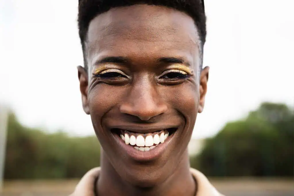 Happy African gay man smiling in front of camera